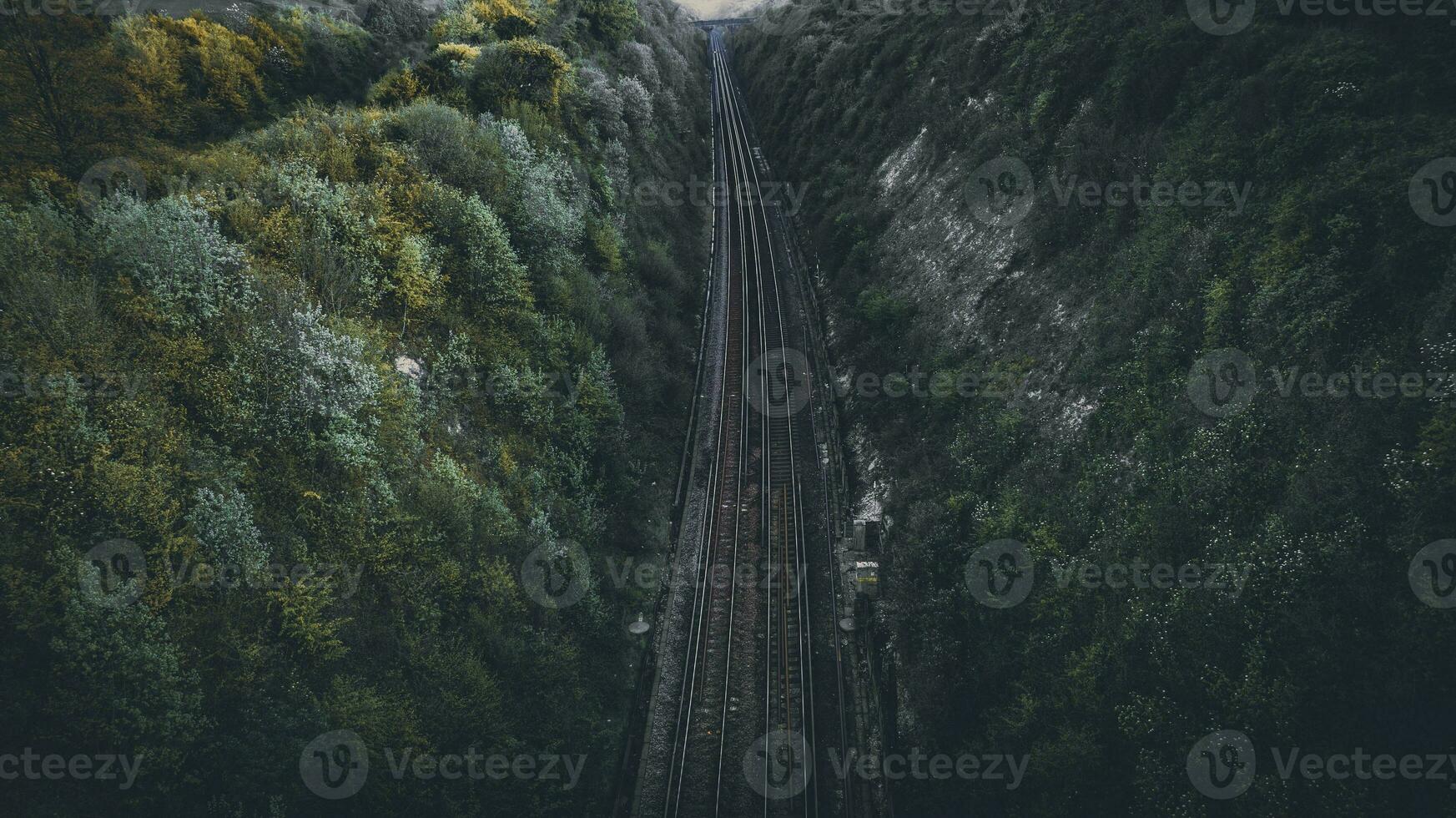 Aerial view of a moody railroad track in a conyon, east sussex, uk photo