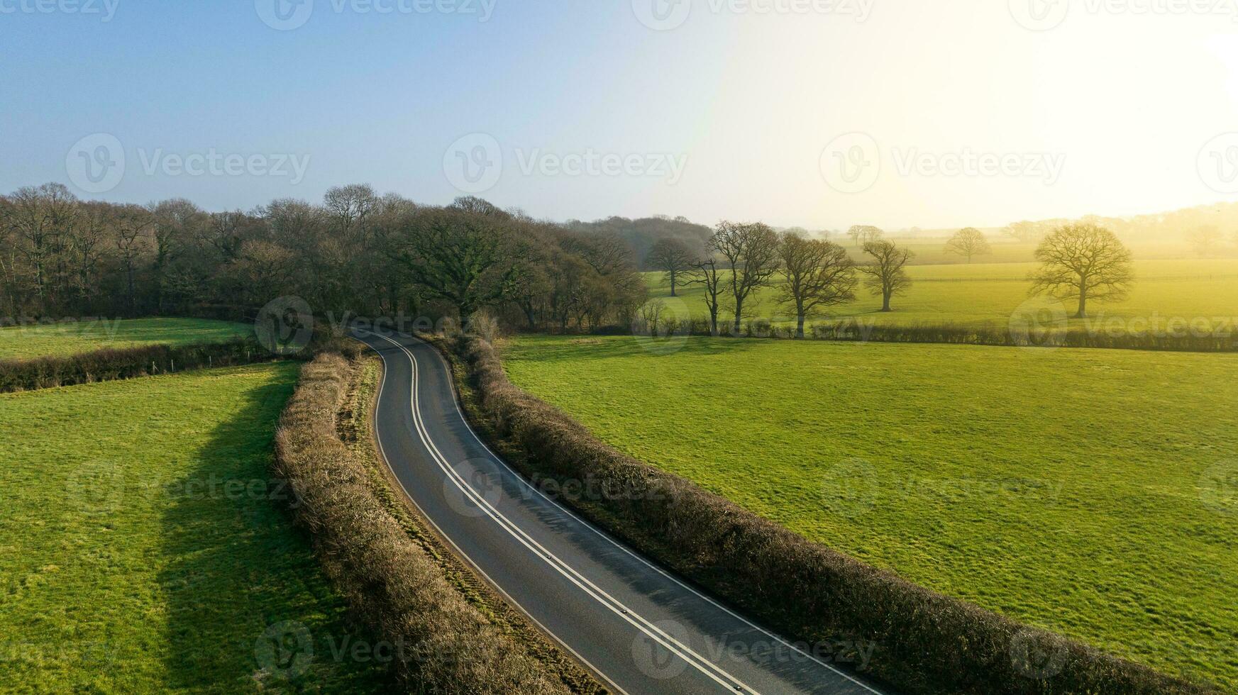 Aerial view of road and trees in spring colours, West Sussex, UK. photo