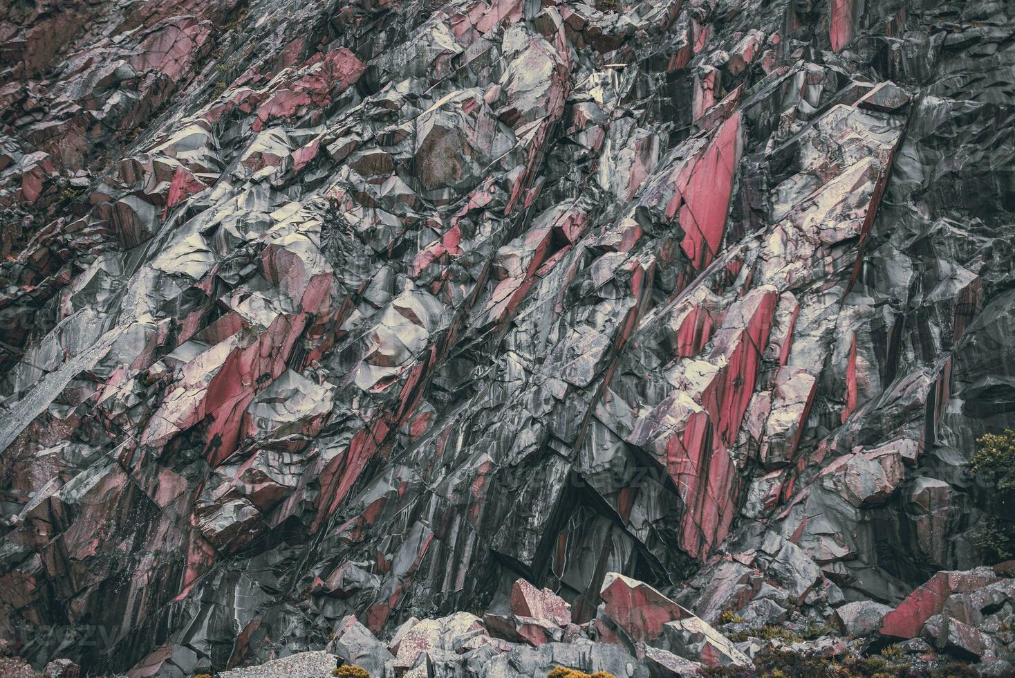 Compressed stone layers on a montain in abandon old mines quarry in Llanfairfechan, North Wales, Cymru, UK photo