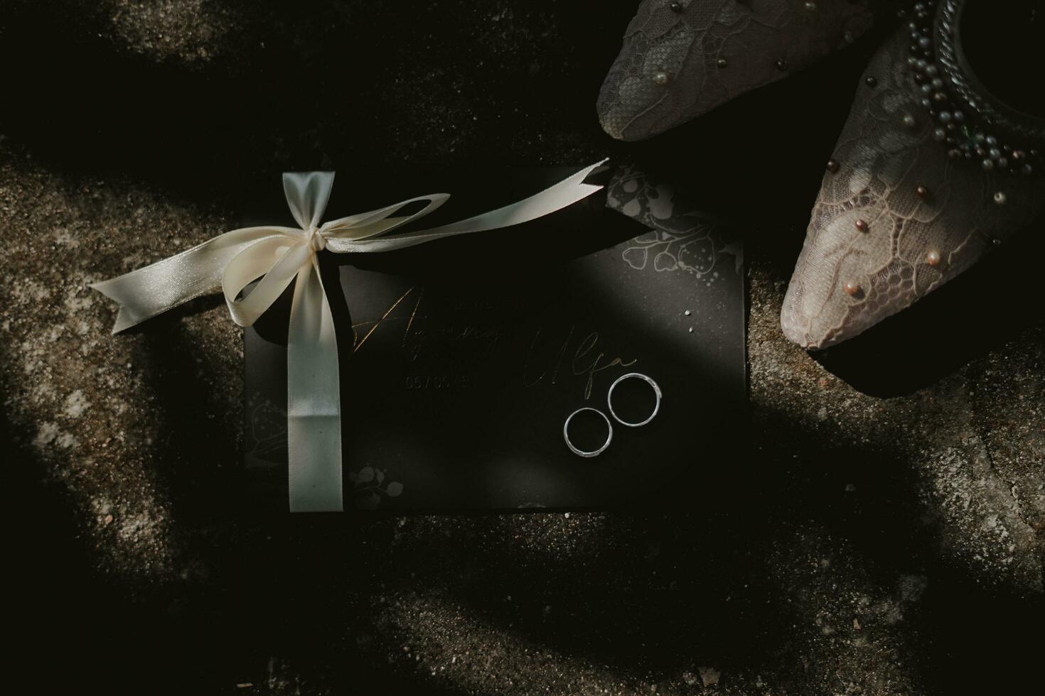 a black box with a bow and two rings photo