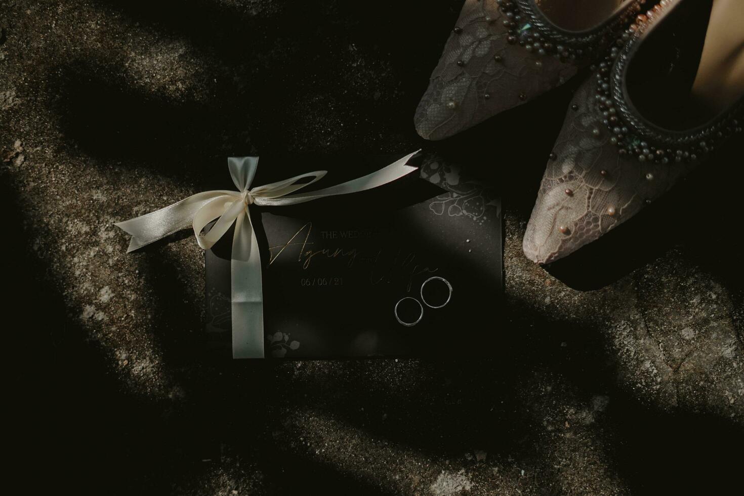 wedding shoes and ring on the ground photo