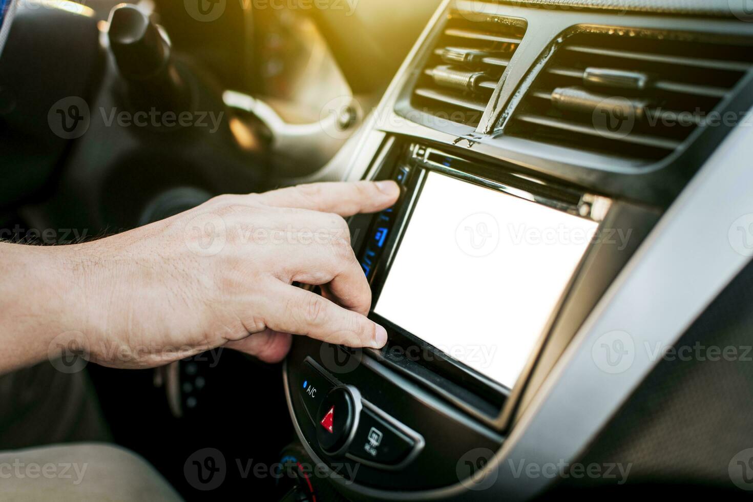 Driver hands changing the radio station. Close up of hands changing the car radio station. Concept of driver tuning the radio. Driver man changing radio station photo