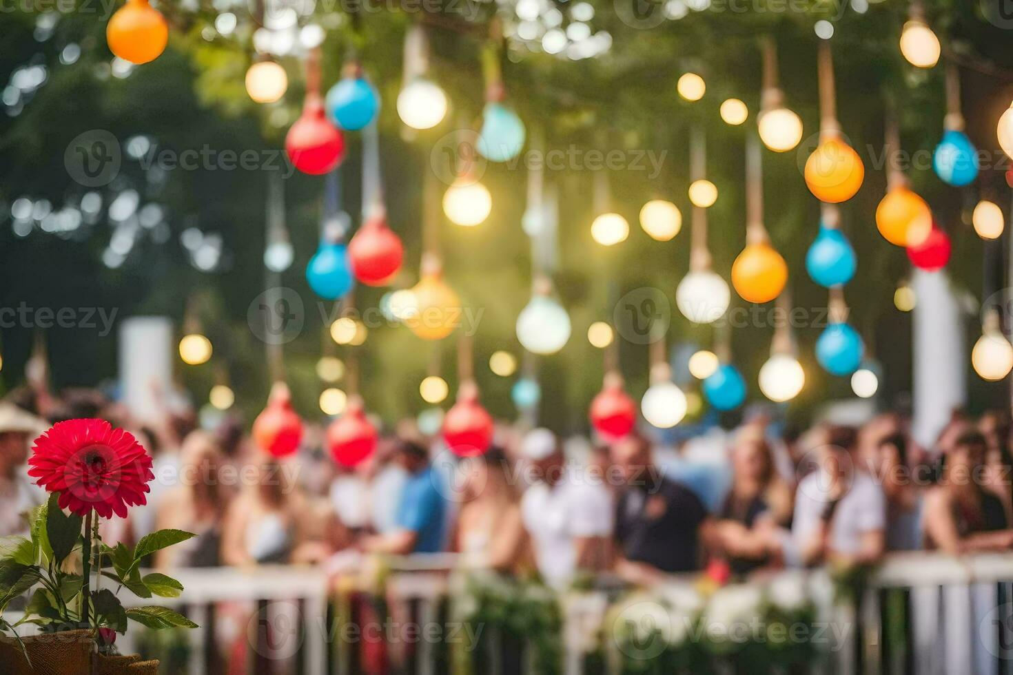 a group of people standing in front of a fence with colorful lights hanging from it. AI-Generated photo