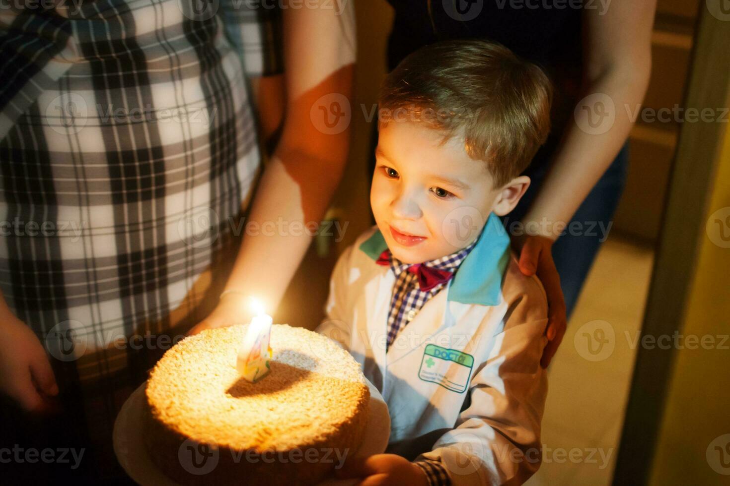 Little boy carrying birthday cake photo