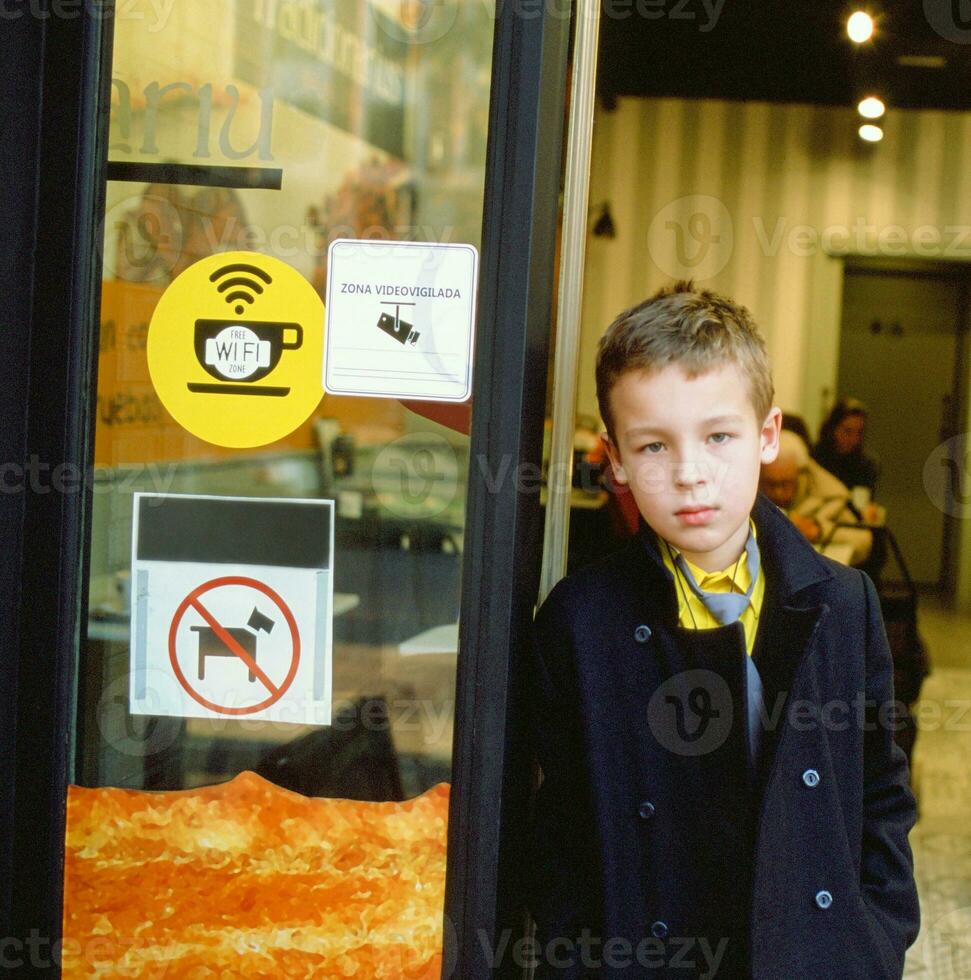 Schoolchild at the cafe doorway photo