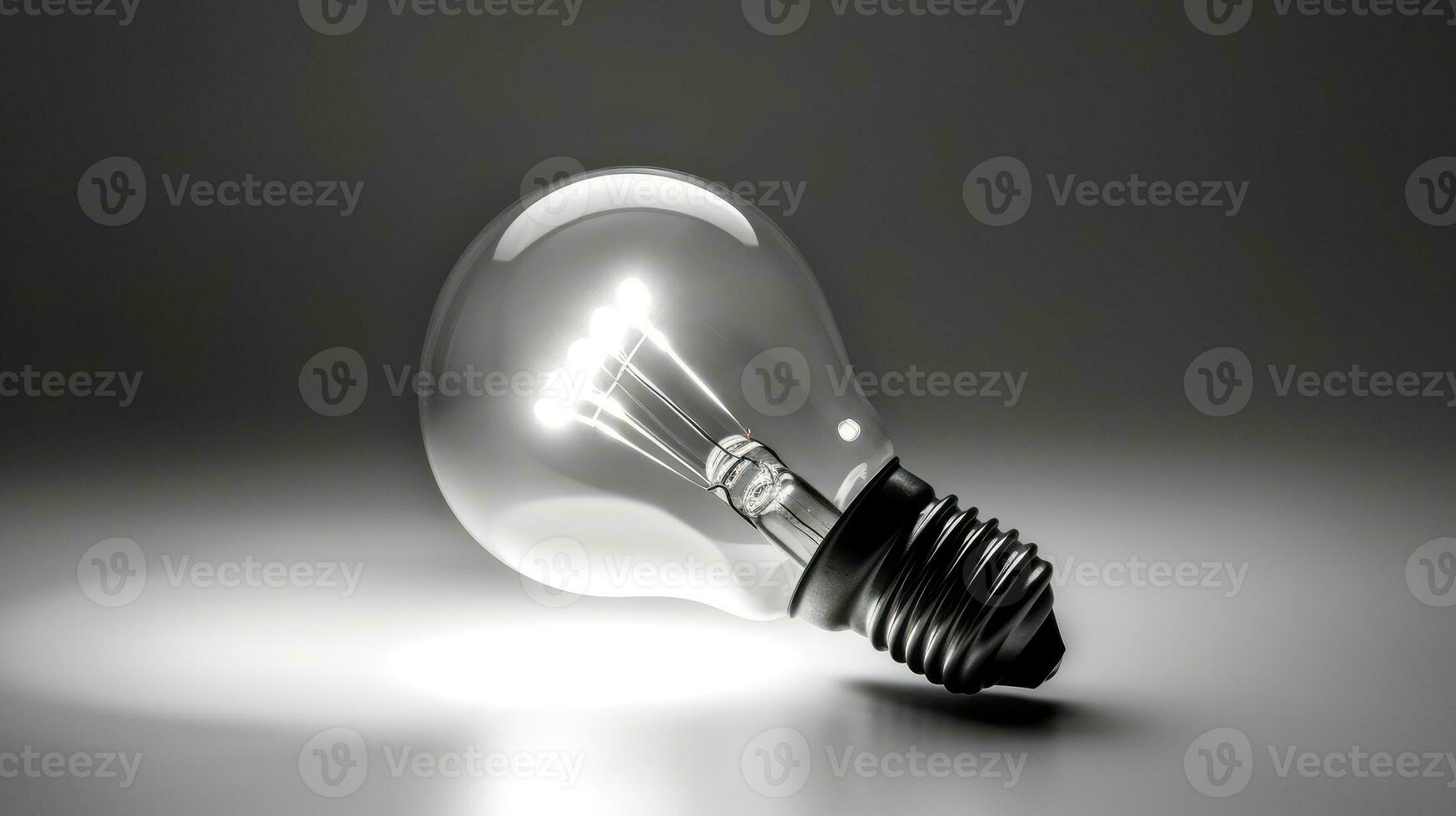 Glowing light bulb on grey background. photo