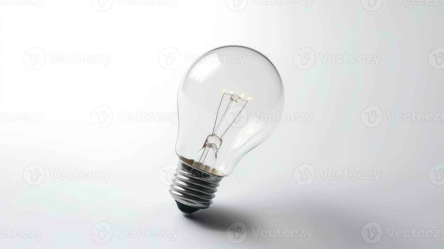 Glowing glass light bulb on grey background photo