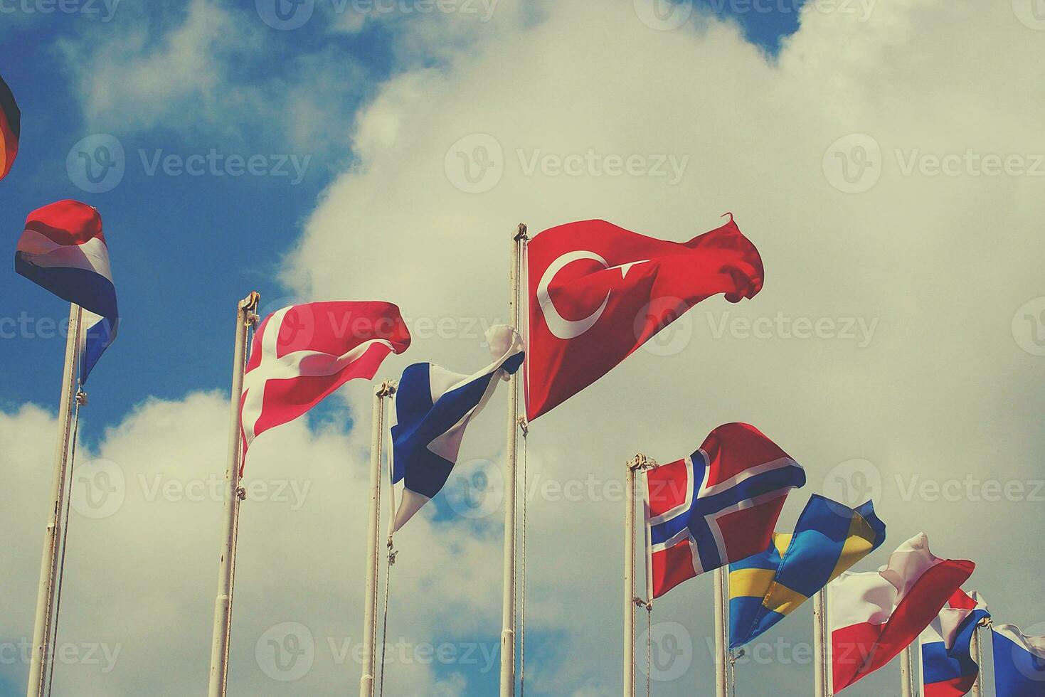 Turkish flag waving in the wind on a summer warm day against the sky photo
