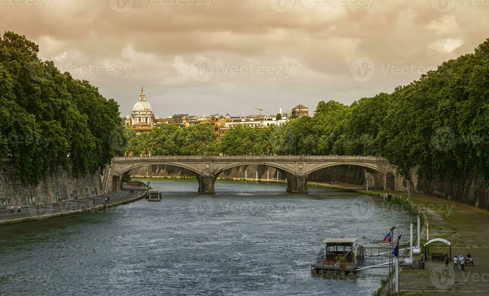 Bridge on the river Tiber and dome of St. Peter's Basilica in Rome, Italy photo