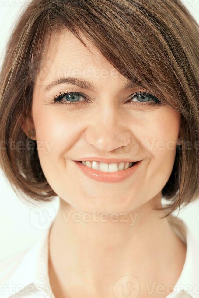 Headshot of adult woman with toothy smile. photo