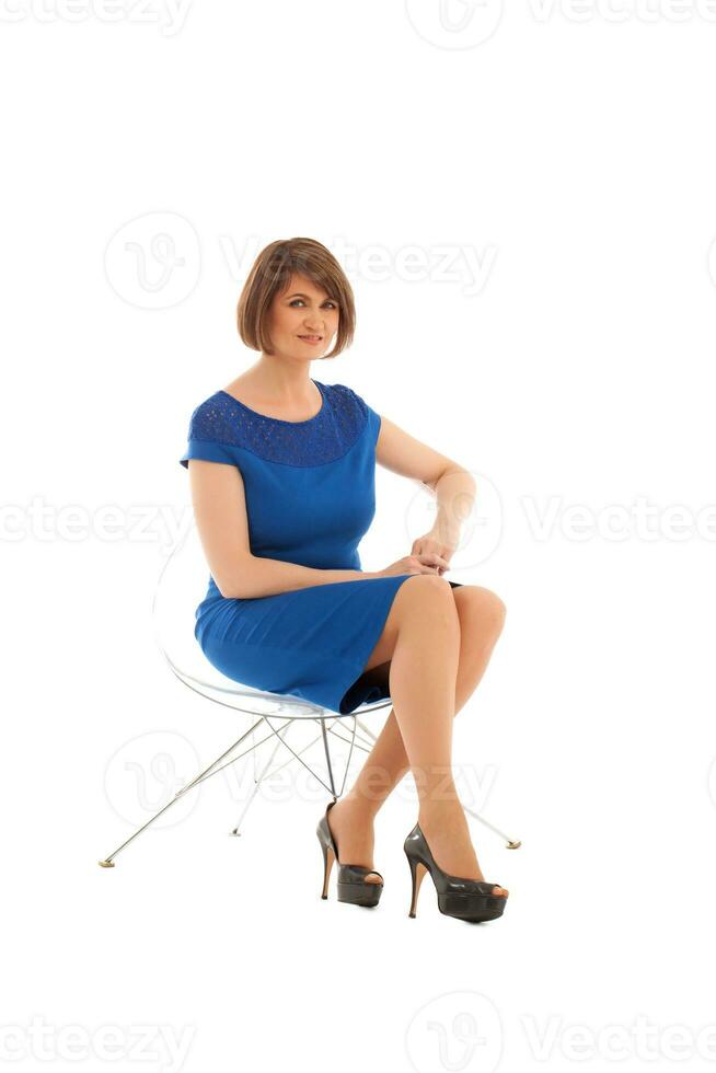 Short haired woman sitting on transparent chair photo