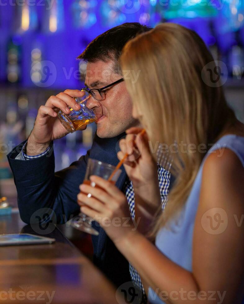 Young people drinking in the bar photo