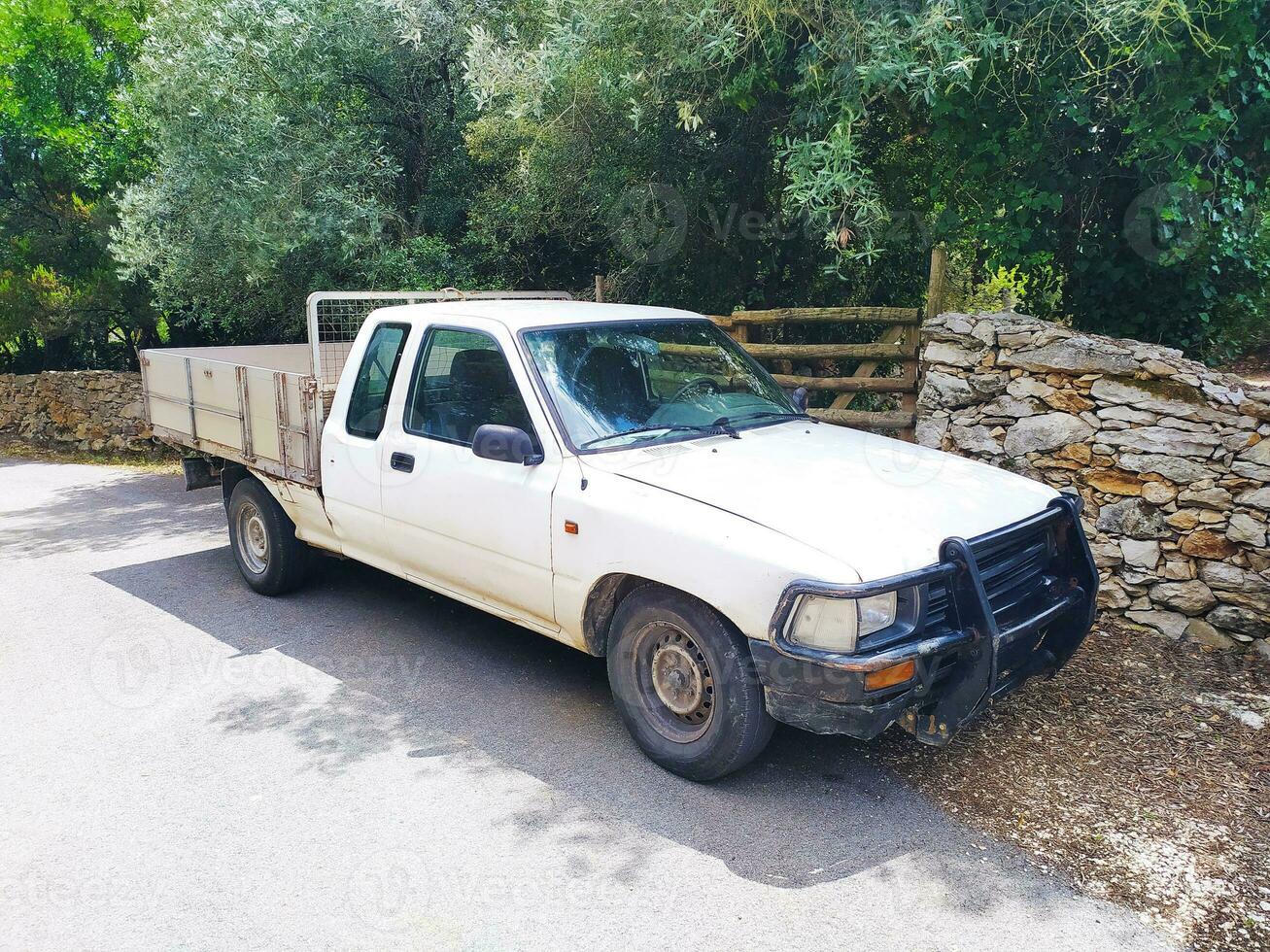 Old pickup truck on a rural road. Classic white car photo