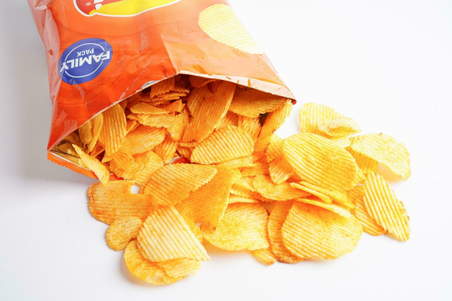Bangkok, Thailand - May 15, 2022 Potato chips in open bag, delicious BBQ seasoning spicy for crips, thin slice deep fried snack fast food. photo