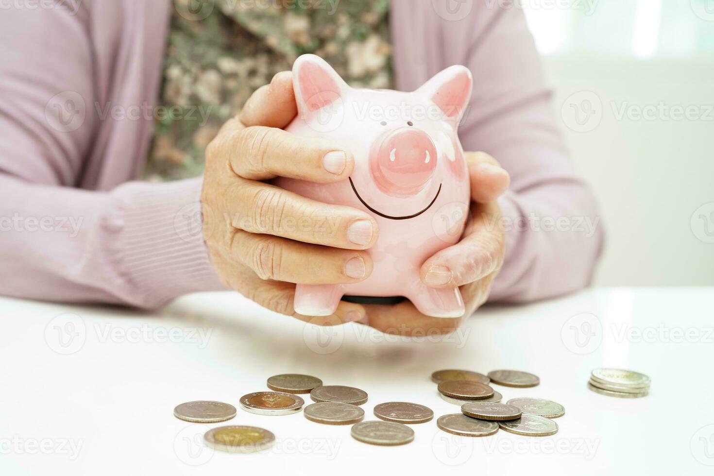 Retired elderly woman counting coins money with piggy bank and worry about monthly expenses and treatment fee payment. photo