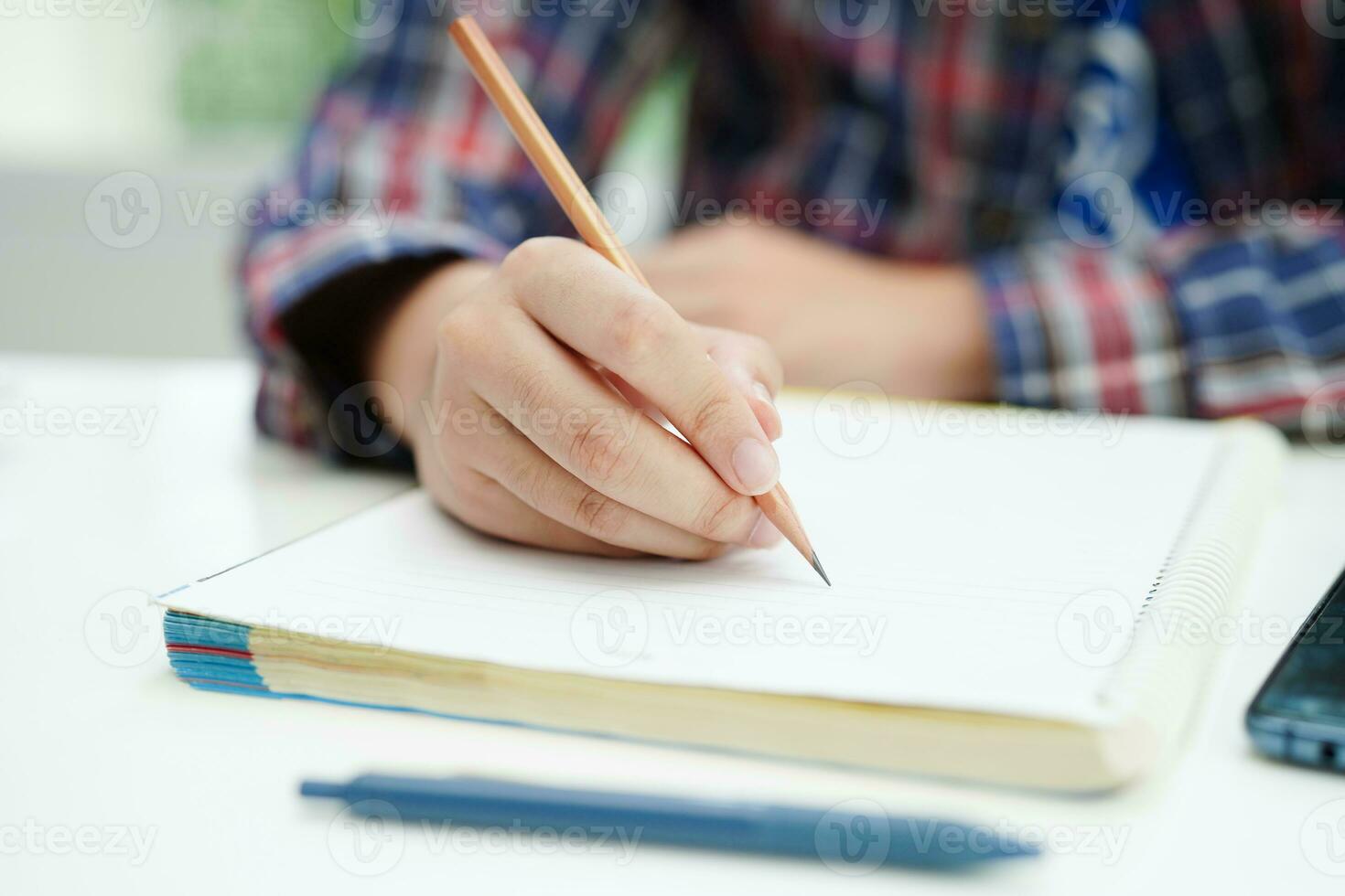 Asian teenage student write homework, study lesson for exam online learning education. photo