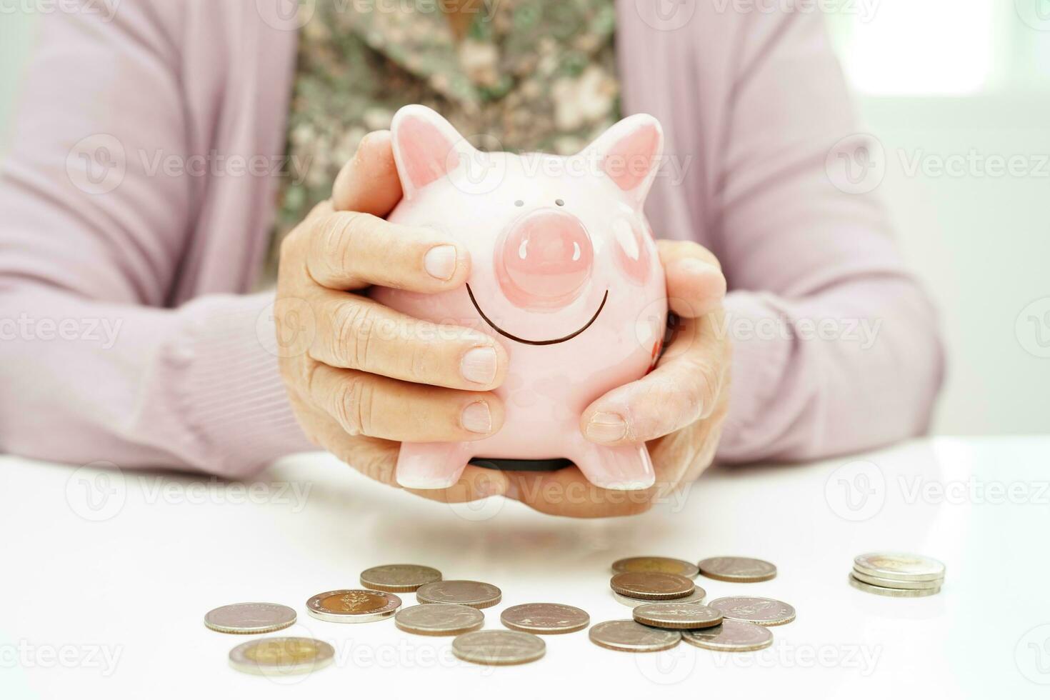 Retired elderly woman counting coins money with piggy bank and worry about monthly expenses and treatment fee payment. photo