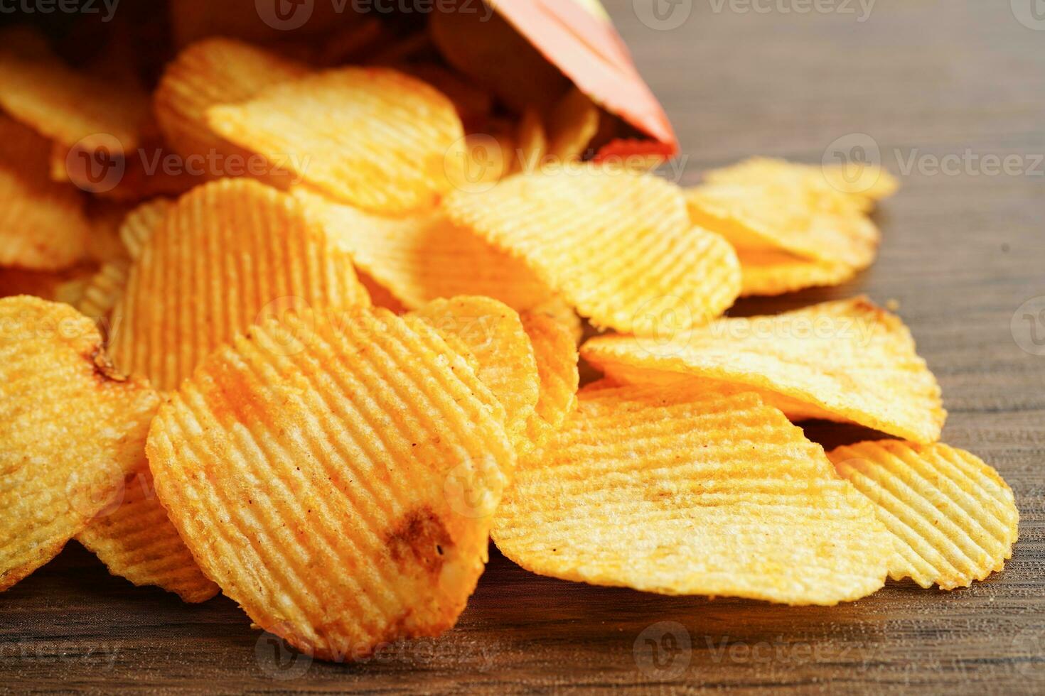 Potato chips in open bag, delicious BBQ seasoning spicy for crips, thin slice deep fried snack fast food. photo
