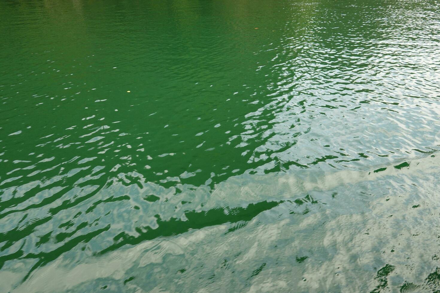 River water is green color of soft waves, background photo texture