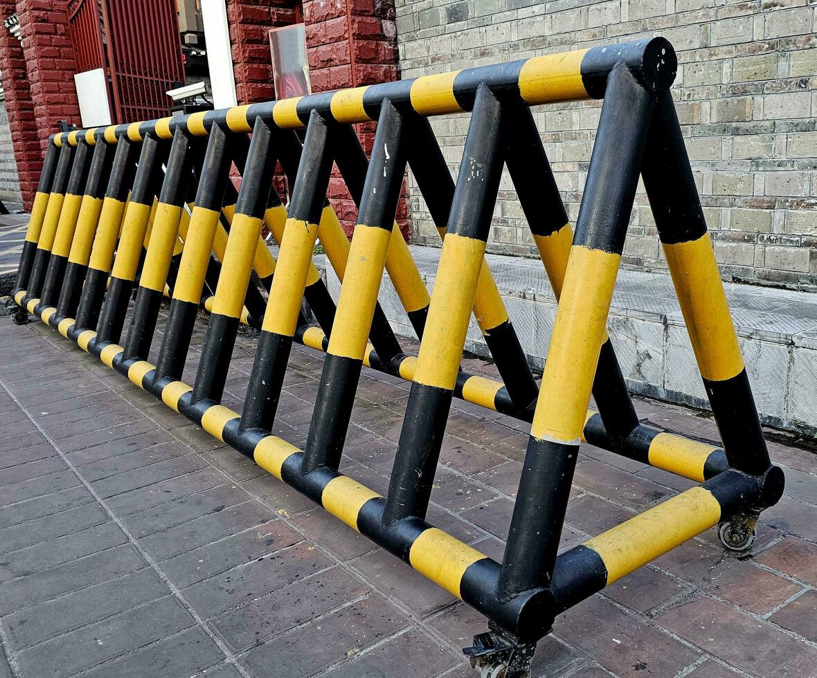 The car barrier on the road to the private office area. Iron yellow-black blocking the road to road transport barrier. Barrier of private property photo