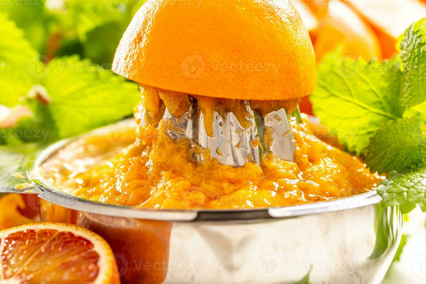 Staniless steel juicer full of orange pulp - close up photo