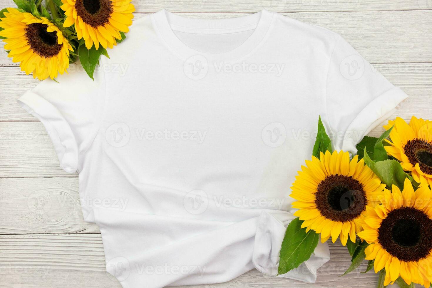 White womens cotton T Shirt mockup with sunflowers on white wooden background. Design t shirt template, print presentation mock up. Top view flat lay. photo