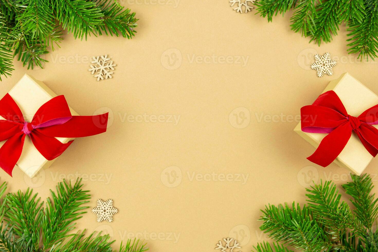 Christmas border flat lay with gift boxes and red ribbon decoration, xmas tree branches on craft paper background. Festive styled mockup composition. Top view. Copy space. photo