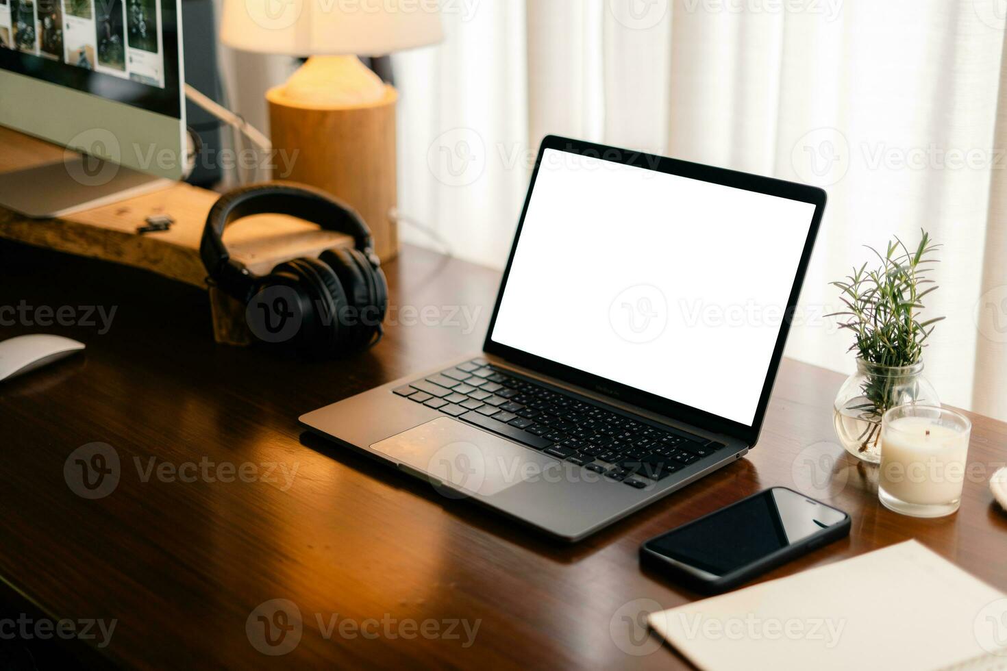 Laptop with blank screen on wooden table photo