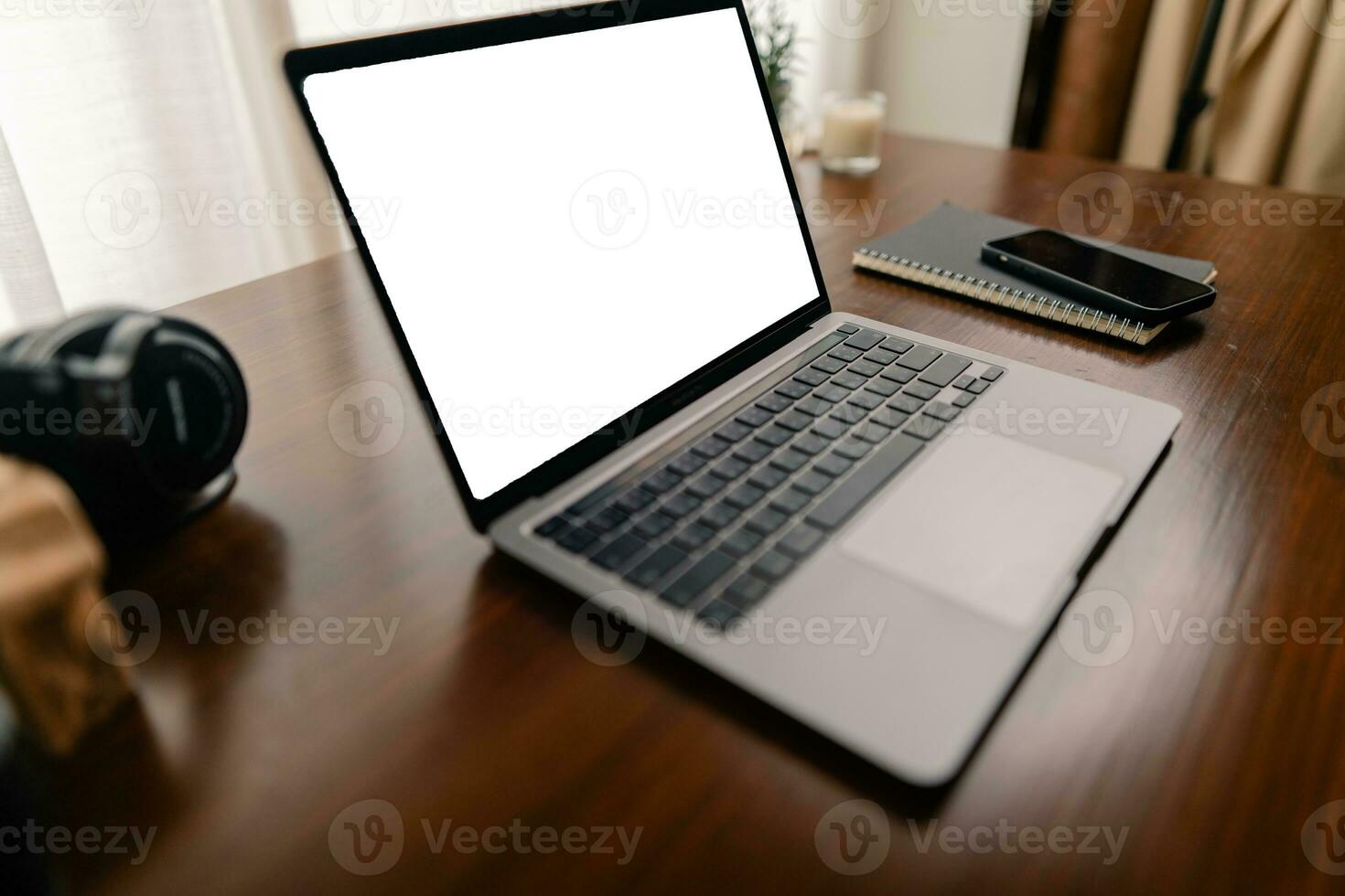 Laptop with blank screen on wooden table photo