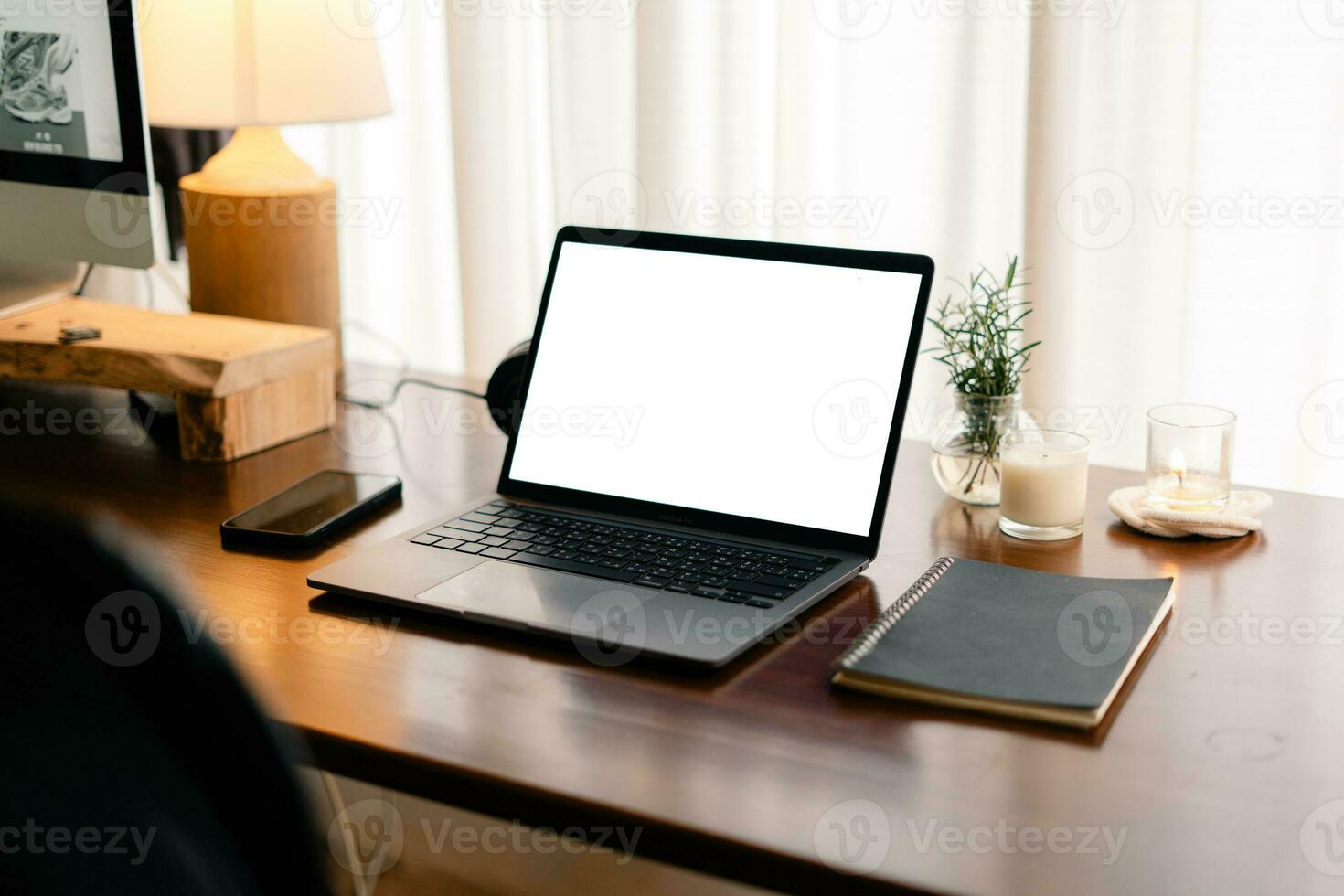 Laptop with blank screen on wooden table photo