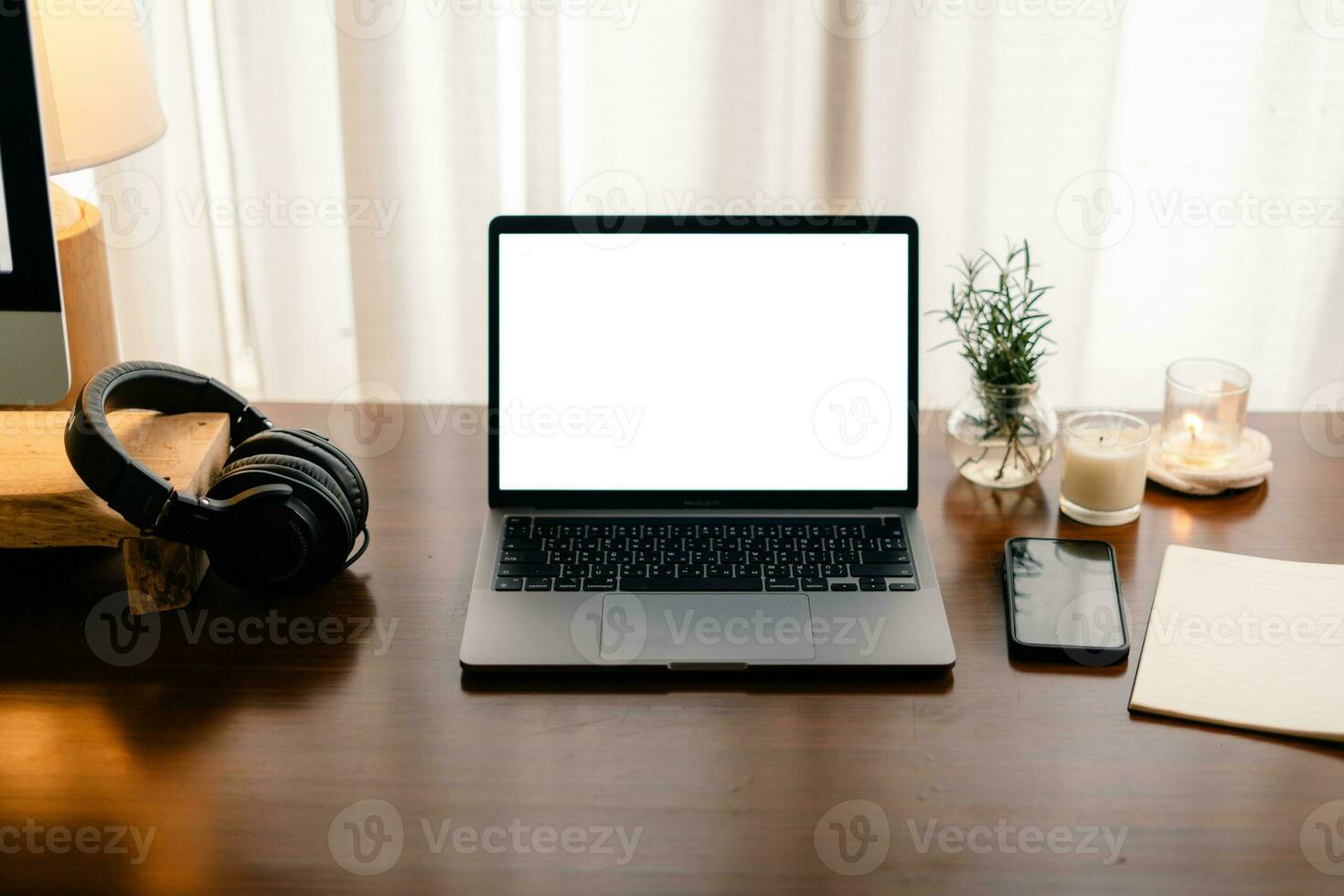 Laptop with blank screen on wooden table photo