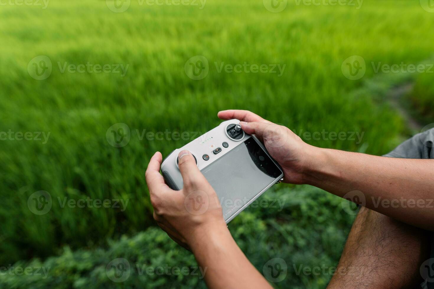 Drone remote control in hand, piloting the drone photo