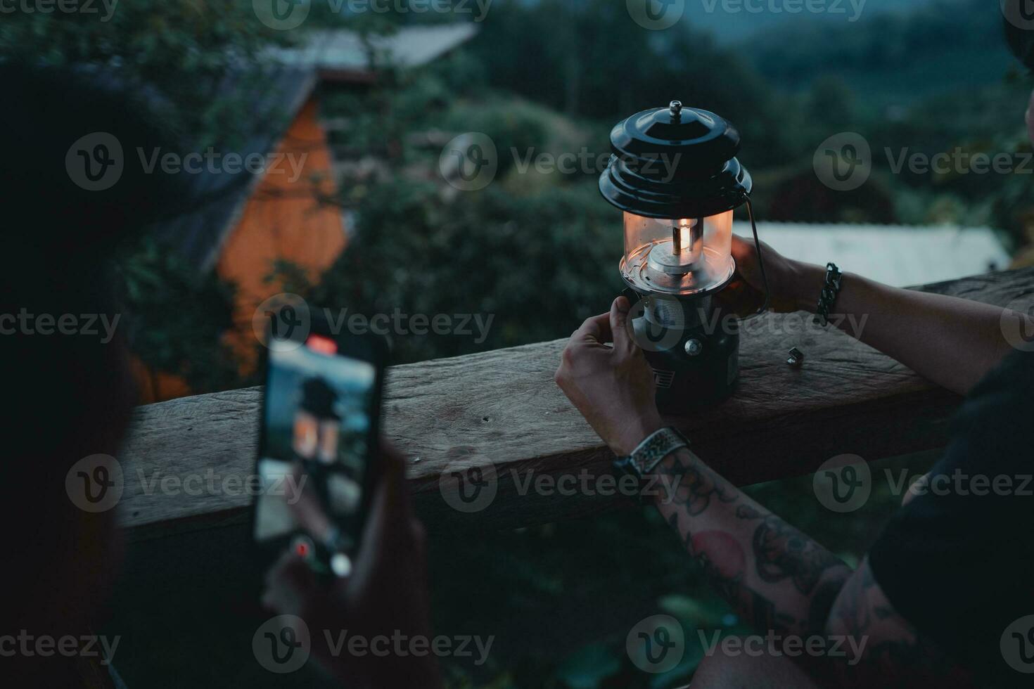 lantern on the balcony,hand is lighting a lantern on the balcony at dusk. photo