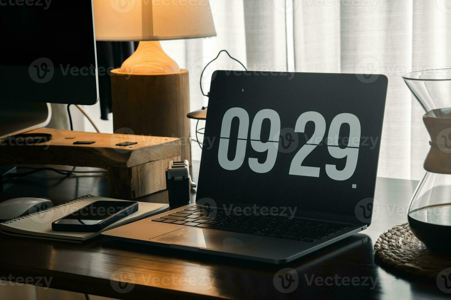 Home computer desk and digital clock on screen photo