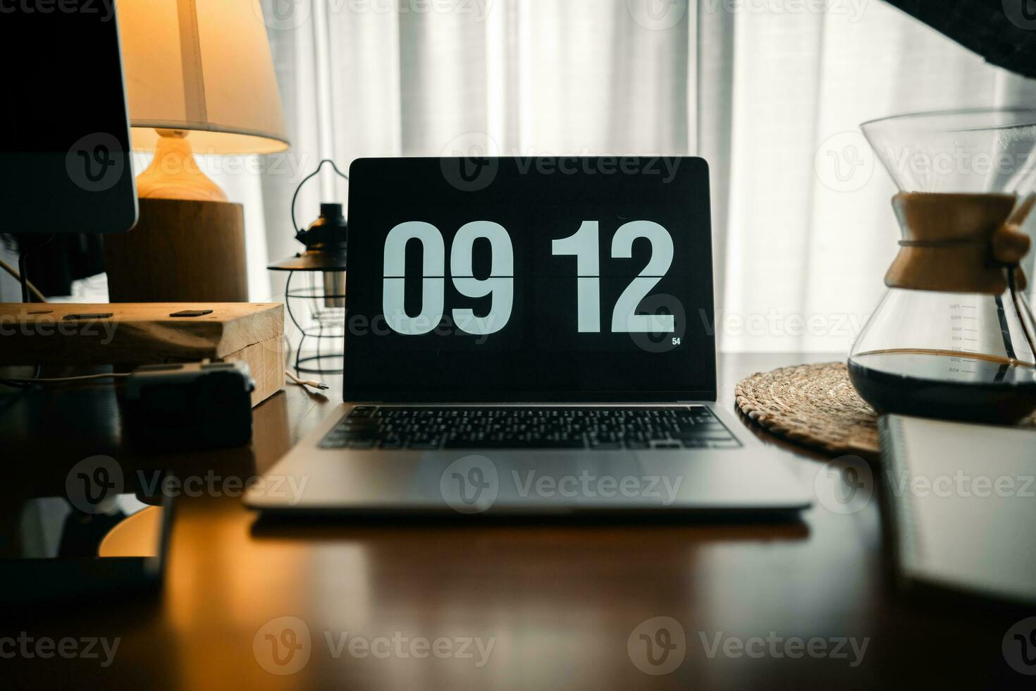 Home computer desk and digital clock on screen photo