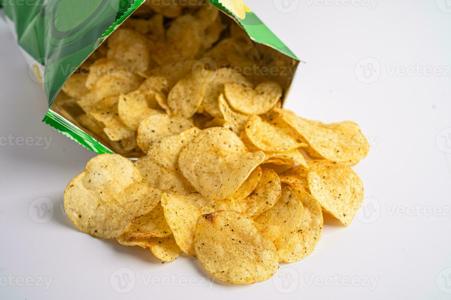 Potato chips, delicious spicy for crips, thin slice deep fried snack fast food in open bag. photo