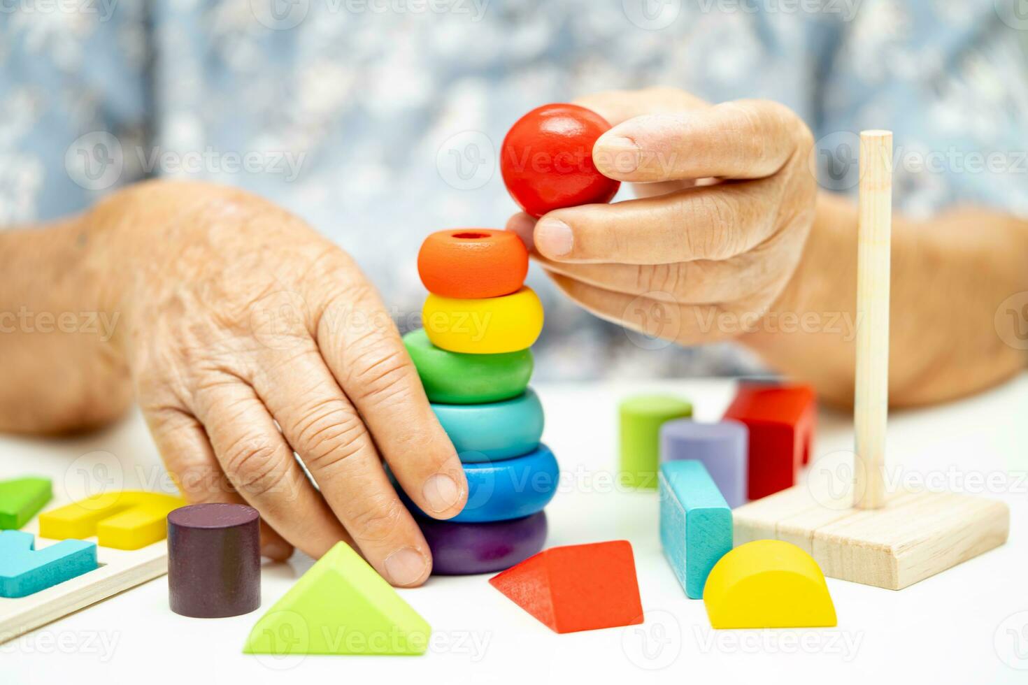 Alzheimer disease AD, Asian elderly woman patient suffering from dementia learn practical motor skills rehabilitation. photo