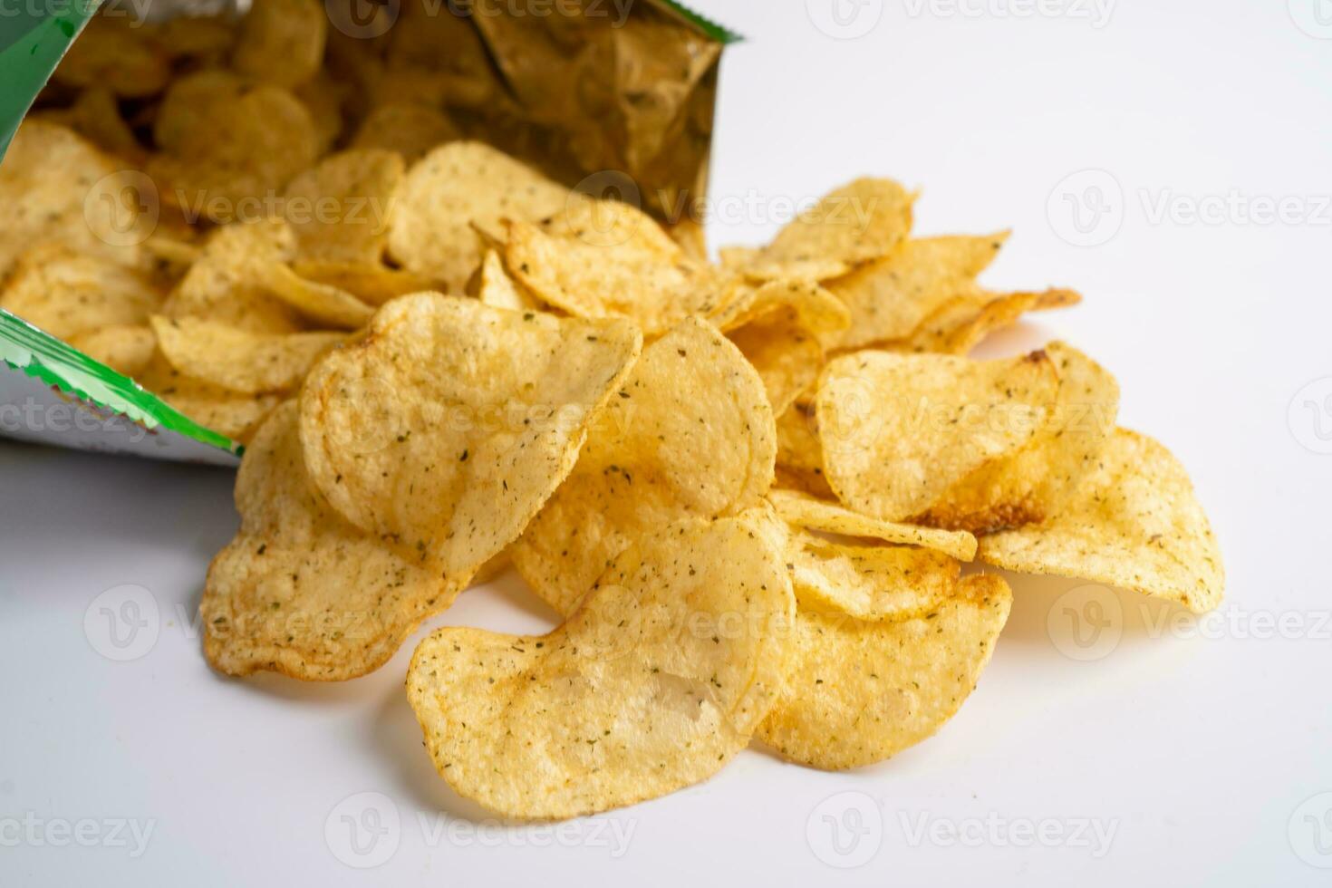 Potato chips, delicious spicy for crips, thin slice deep fried snack fast food in open bag. photo