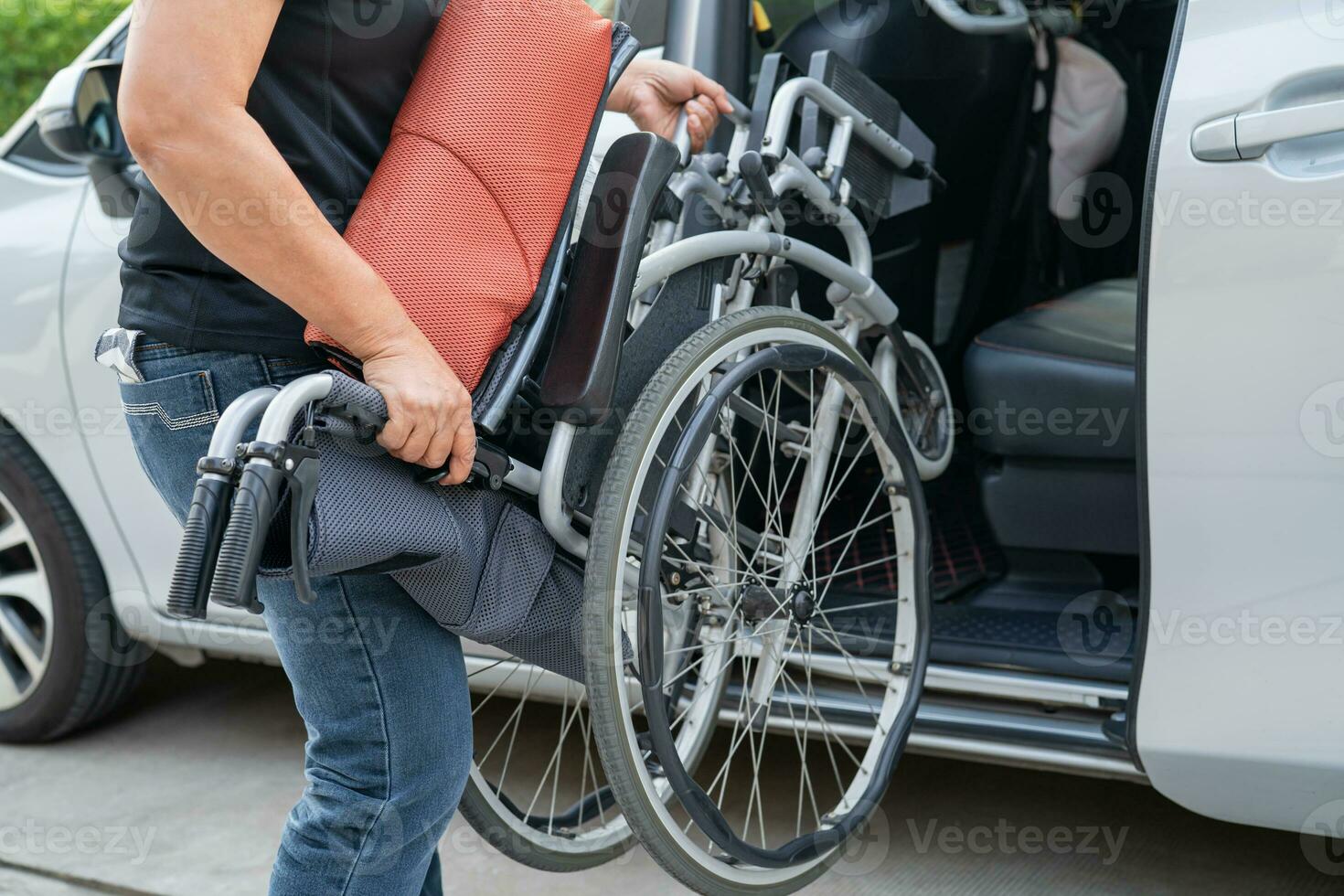 Asian disability woman on wheelchair getting in her car, Accessibility concept. photo