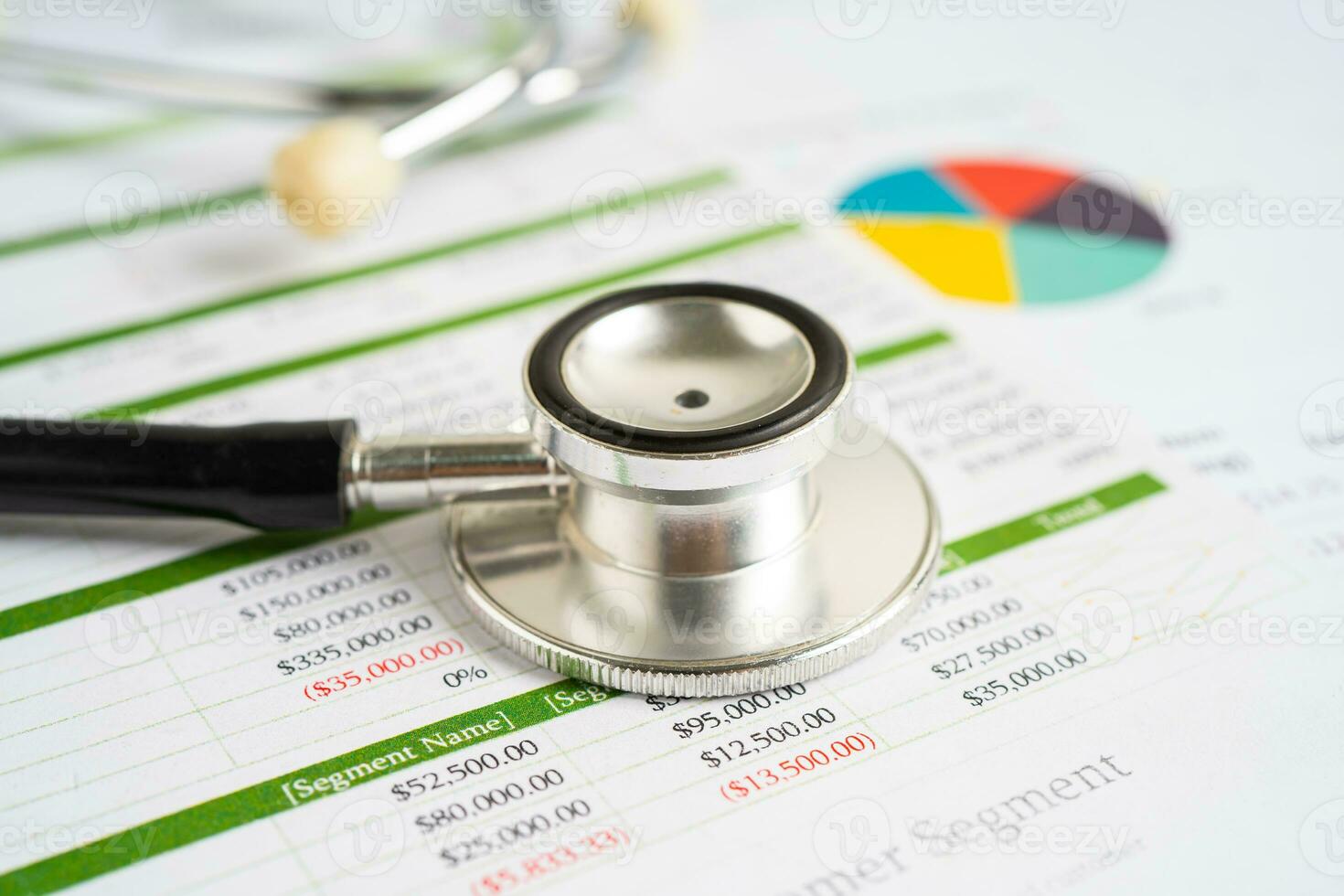 Stethoscope on spreadsheet and graph paper, Finance, Account, Statistics, Investment, Analytic research data economy and Business company concept. photo