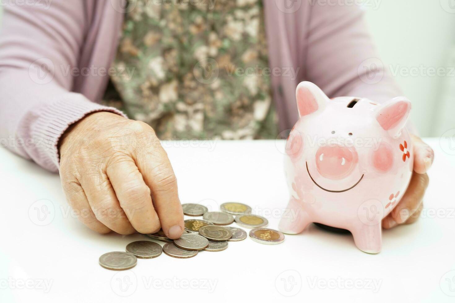 Retired elderly woman counting coins money with piggy bank and worry about monthly expenses and treatment fee payment. photo