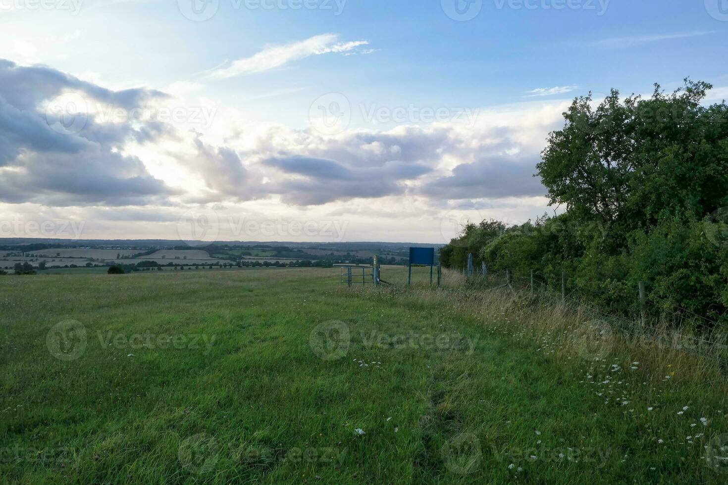 High Angle Panoramic Landscape View of British Agricultural Farms at Countryside Landscape of Sharpenhoe Clappers, Luton City of England UK. Footage Captured on August 19th, 2023 photo