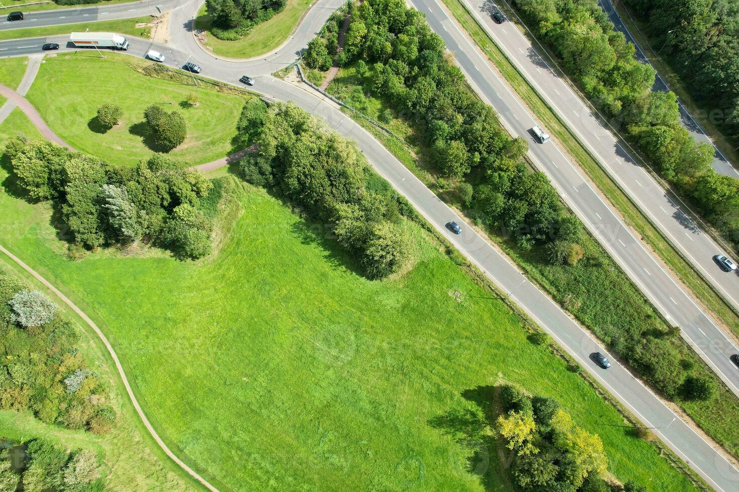 High Angle Footage of British Road and Traffic at Caldecotte Lake of Milton Keynes City of England Great Britain, Beautiful View Captured on August 21st, 2023 with Drone's Camera During Sunny Day photo