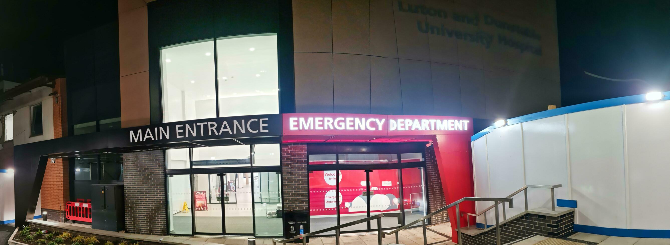 Low Angle Illuminated View of Emergency Entrance of Luton and Dunstable Hospital at Luton City of England UK During Midnight of Sep 3rd, 2023. Hospital's Building is Under construction for Renovation photo