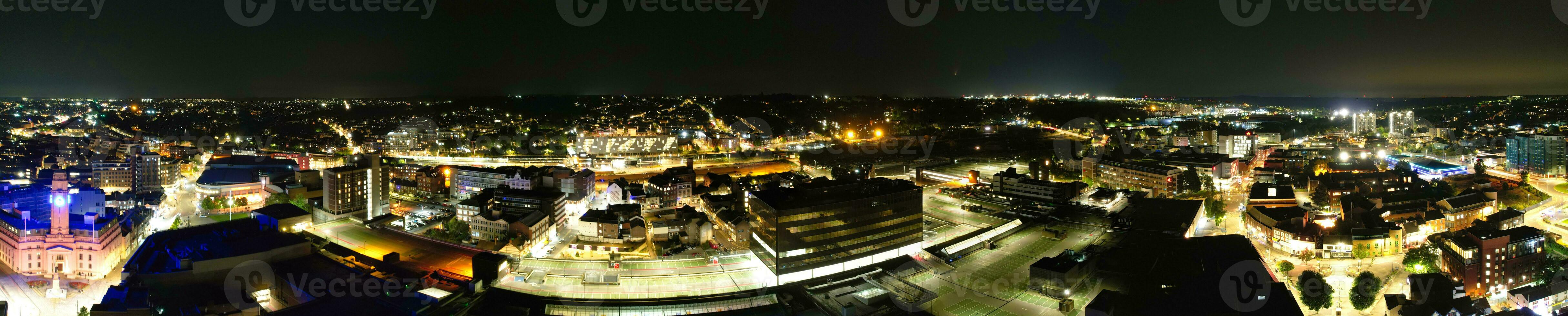 Ultra Wide Aerial Panoramic View of Illuminated Downtown Buildings, Roads and Central Luton City of England UK at Beginning of Clear Weather's Night of September 5th, 2023 photo