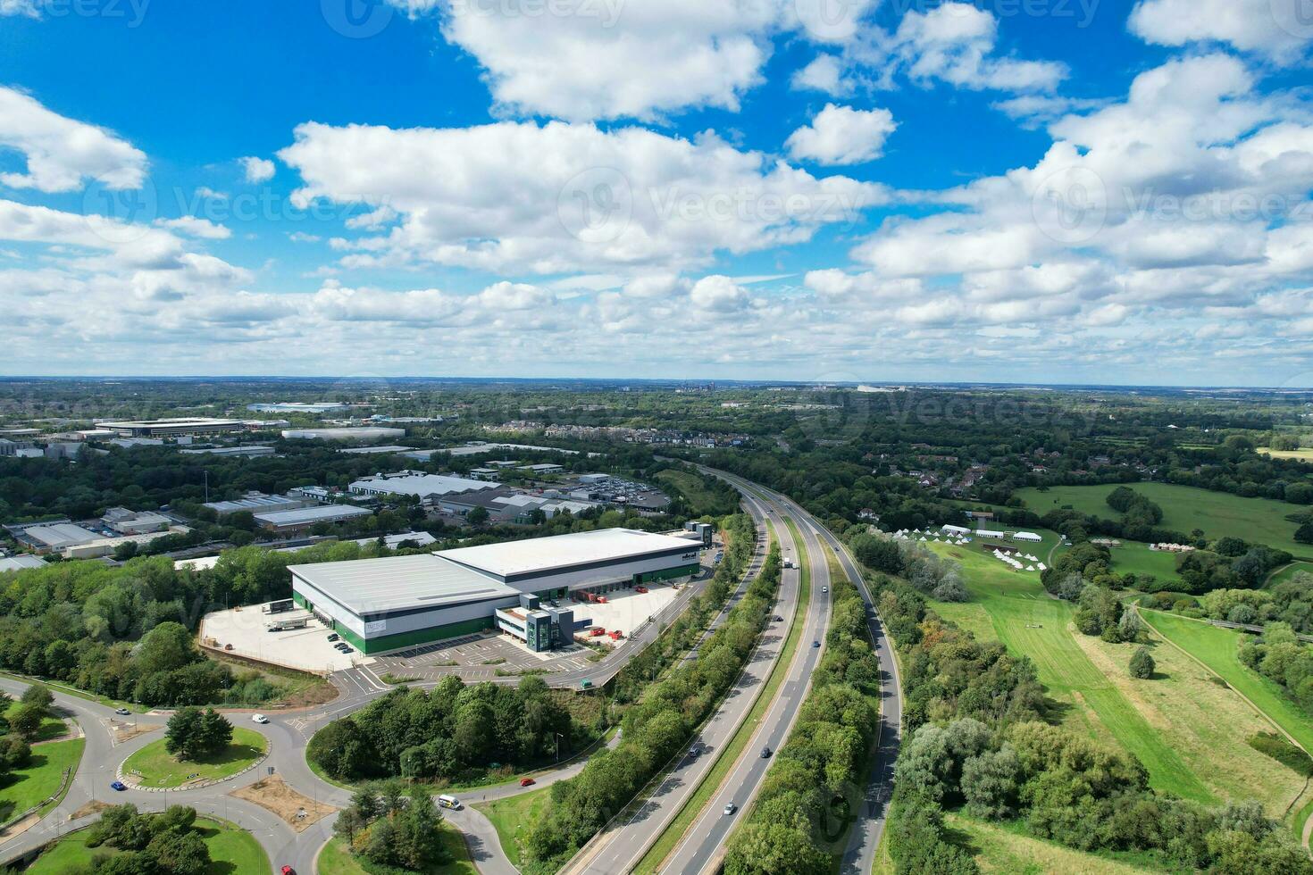 High Angle Footage of British Road and Traffic at Caldecotte Lake of Milton Keynes City of England Great Britain, Beautiful View Captured on August 21st, 2023 with Drone's Camera During Sunny Day photo