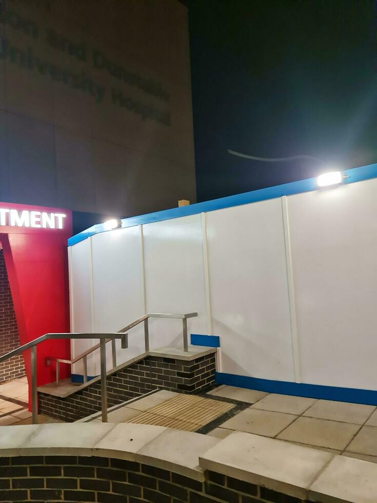 Low Angle Illuminated View of Emergency Entrance of Luton and Dunstable Hospital at Luton City of England UK During Midnight of Sep 3rd, 2023. Hospital's Building is Under construction for Renovation photo