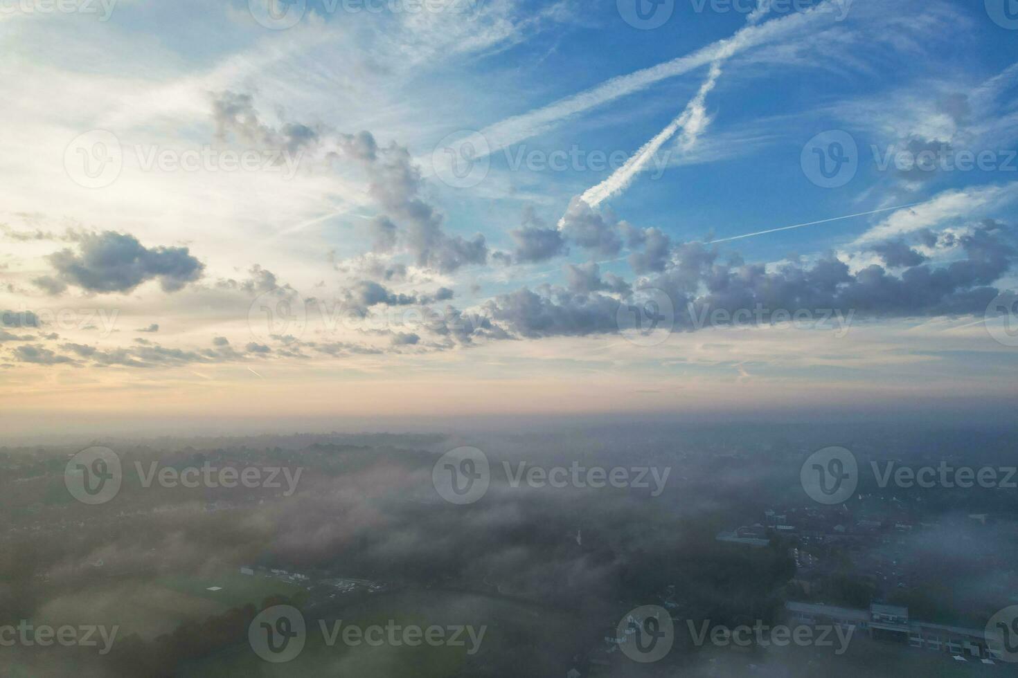 Most Beautiful and Best High Angle Dramatical Colourful Sky Footage from Above The Clouds. The Fast Moving Clouds During Sun rising Early in the Morning over Luton City of England UK photo