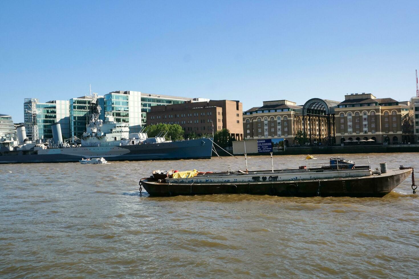 Best View of Boat over River Thames Waters at London Bridge, Capital City of England Great Britain. The Image Was Captured June 4th, 2023 photo