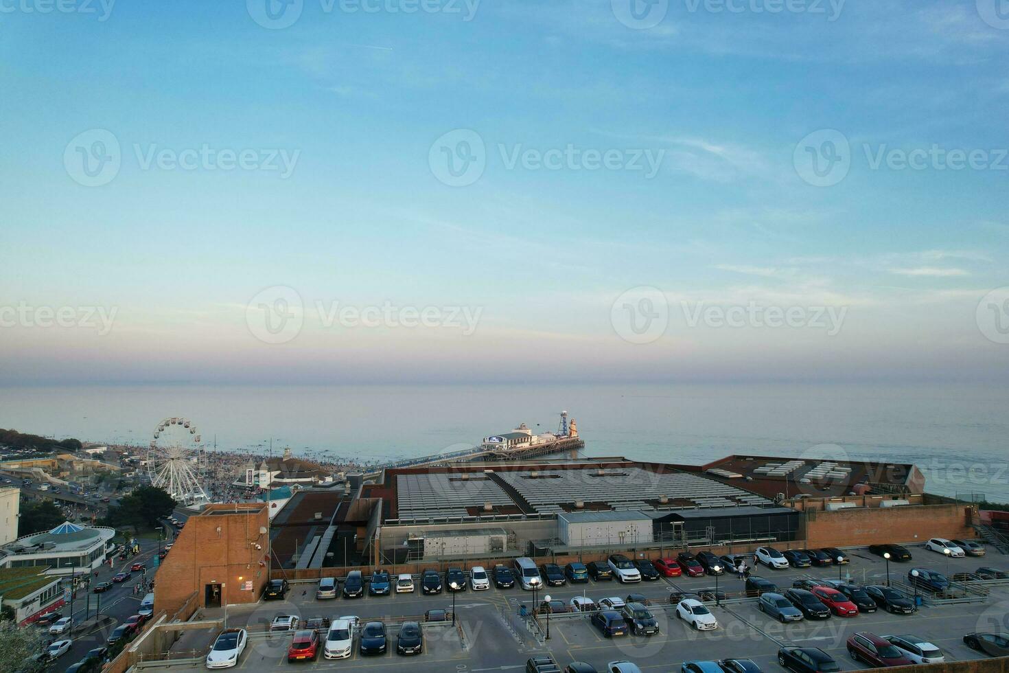 Aerial View of British Tourist Attraction of Bournemouth Beach and Sea view City of England Great Britain UK. Image Captured with Drone's Camera on September 9th, 2023 During Sunset photo